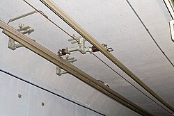 Two overhead conductor rails for the same track. Left, 1,200 V DC for the Uetliberg railway (the pantograph is mounted asymmetrically to collect current from this rail); right, 15 kV AC for the Sihltal railway