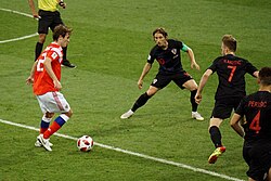 Modrić (center) and Ivan Rakitić defending during the 2018 World Cup