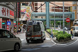 Rear view of an emergency response van belonging to the Macau Health Bureau driving on a city street near Hotel Lisboa.