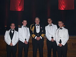 An example of Merchant Navy officers, graduating at their 'passing out' ceremony from Warsash Maritime Academy in Southampton, with former First Sea Lord Alan West, Baron West of Spithead, in 2011.
