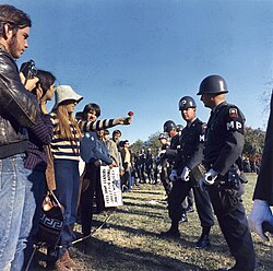 A female demonstrator offers a flower to a soldier during the 1967 March on the Pentagon anti-Vietnam War protest.