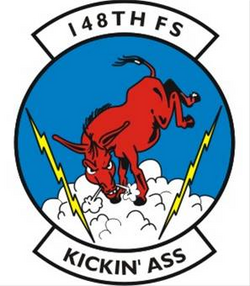 The United States Air Force 148th Fighter Squadron emblem, a visual pun in which the squadron's motto, "Kickin' Ass", is depicted literally as an ass in the act of kicking even though "kicking ass" is a colloquial expression for winning decisively or being impressive.
