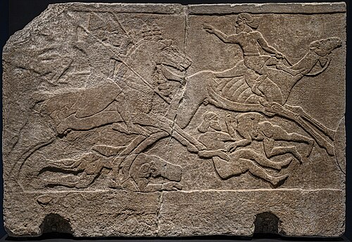 Relief from Tiglath-Pileser's palace in Nimrud depicting Assyrian riders pursuing a camel rider