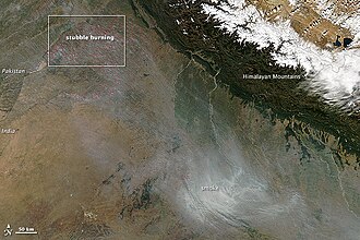 During the autumn and spring months, some 500 million tons of rice and wheat crop residues are burnt, and winds blow from India's north and northwest towards east.[48][49][50] This aerial view shows India's annual crop burning, resulting in smoke and air pollution over Delhi and adjoining areas.