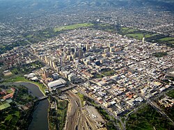 Aerial view of Greater Adelaide, the parklands serve as a barrier between the inner CBD and encompassing urban area