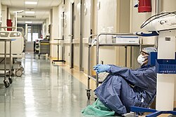 Exhausted nurse takes a break in an Italian hospital during the COVID-19 emergency.