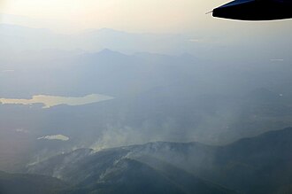 Aerial view of deliberate wildfires on the Khun Tan Range, Thailand. These fires are lit by local farmers every year to promote the growth of a certain mushroom.