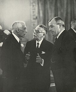 Edge (right) confers with Andrew W. Mellon and British ambassador William Tyrrell, 1st Baron Tyrrell, photographed by Erich Salomon in Famous Contemporaries in Unguarded Moments.