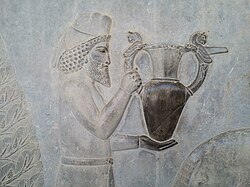 An Armenian tribute bearer carrying a metal vessel with griffin handles. Persepolis, 5th century BC.