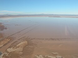 The Rogers Lake is not always dry. During the brief rainy season in the Mojave Desert, water fills the lakebed. The compass rose can be seen on the left.