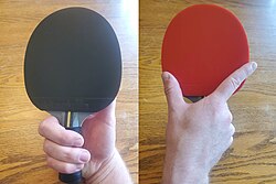 The forehand (black) and back side (red) view of the Seemiller (Ann Alvarez) grip. The back side is not used, though sometimes the player will flip the racket to use the other rubber on the forehand.