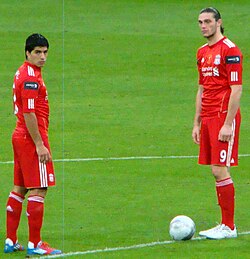 Suárez (left) was signed by Liverpool on the same day as Andy Carroll.
