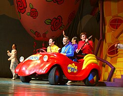 The Wiggles' lineup in 2007, riding in the Big Red Car during a concert