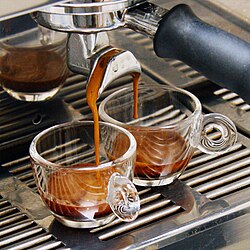 Espresso is a coffee brewed by forcing a small amount of nearly boiling water under pressure through finely ground coffee beans. The term espresso comes from the Italian esprimere, which means 'to express', and refers to the process by which hot water is forced under pressure through ground coffee.[224]