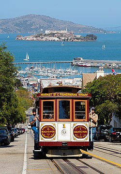 A San Francisco cable car with Alcatraz seen behind