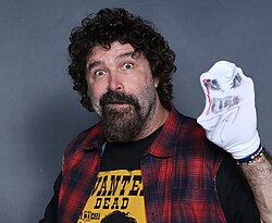 Mick Foley in 2018 wearing "Mr Socko"; he changed the Mankind character and his wrestling style following the match to huge acclaim and success.