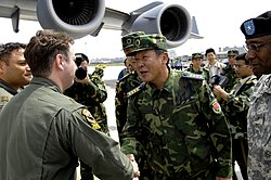 Senior Capt. Guan Youfei greeted the first of two U.S. aircrews delivering earthquake relief supplies