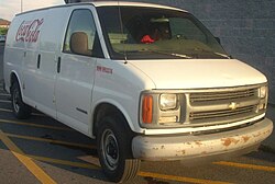 A Chevrolet Express van bearing the logo of the Coca-Cola Company