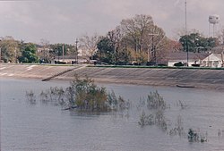 A levee keeps high water on the Mississippi River from flooding Gretna, Louisiana, in March 2005.