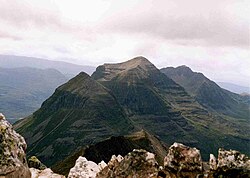 Liathach seen from Beinn Eighe. With the Munro "Top" of Stuc a' Choire Dhuibh Bhig 915 m (3,001 ft) in the foreground and the two Munro summits in the background.