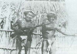 Wayuus carrying a rifle and traditional bow and arrow. 1928.