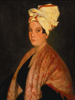 Frank Schneider's painting Portrait of a Creole Woman with Madras Tignon, circa 1915, after an earlier work by George Catlin. This has been interpreted as a possible portrayal of Voodoo priestess Marie Laveau