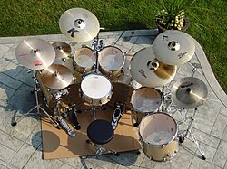 A seven-piece kit typically used for heavy metal, elaborate jazz fusion, and progressive rock, consisting of double bass drums, two-floor toms, and an extended set of cymbals (three crashes with splash and China-type).