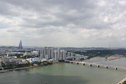 Central Pyongyang with the newly built Changjon Apartment Complex. The Ryugyong Hotel and Okryu Bridge are in the background