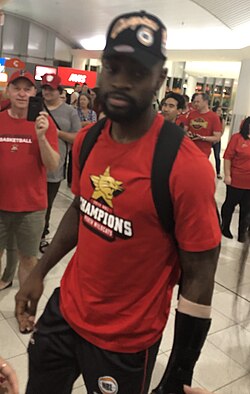 White in March 2019, wearing a cast on his left arm after winning the championship with the Wildcats