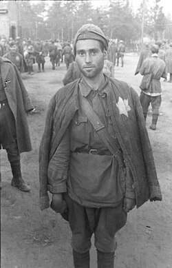 A Jewish Soviet soldier taken prisoner by the German Army, August 1941. At least 50,000 Jewish soldiers were shot after selection.[139]
