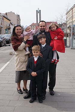Romanian Greek Catholic priest from Romania with his family.
