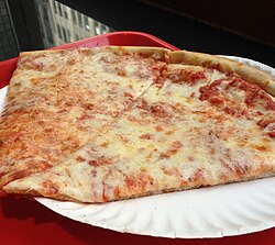 Caramelized crust of slices of New York–style pizza