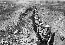 A narrow communication trench, allowing forces and casualties to move between the rear and front lines (April 1916)