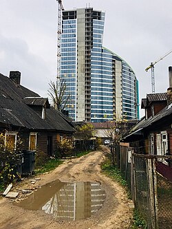 A luxury building towers over a low-income neighbourhood in Vilnius, Lithuania, 2017.