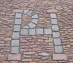 Lutheran pastor Patrick Hamilton's initials, set into the paving stones at the site where he was burned at the stake.