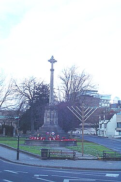 The cross of the war memorial and a menorah coexist in Oxford, Oxfordshire, England