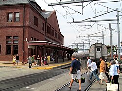 Passengers crossing the State Street crossing in New London after departing a northbound train