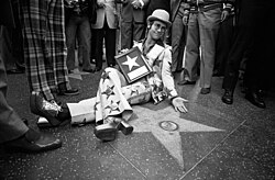 Known for his flamboyant style and virtuosic piano playing, Elton John became one of the biggest pop stars of the 1970s.