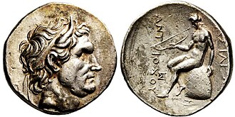 Tetradrachm of Antiochus I. Obverse shows the bust of Seleucus I, with bull's horns. The reverse shows Apollo seated on omphalos, holding bow. Greek legend reads: BAΣIΛEΩΣ ANTIOXOY, Basileōs Antiochou, "of king Antiochus".