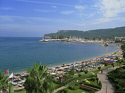 Kemer Beach in Antalya on the Turkish Riviera (Turquoise Coast). In 2019, Turkey ranked sixth in the world in terms of the number of international tourist arrivals, with 51.2 million foreign tourists visiting the country.[201]