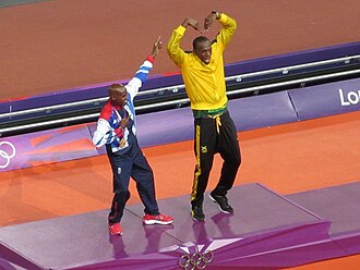Mo Farah (left) with Usain Bolt (right), demonstrating one another's famous gestures (the "Lightning Bolt" and "Mobot")