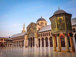 The Umayyad Mosque was built in 715 (Umayyad period), while the Qubbat al-Khazna structure (on the right) was built during the latter Abbasid period