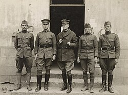 MacArthur (center) in his unauthorized uniform. He never wore a helmet, even in no man's land, and wore a modified cap.[45][46]
