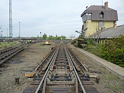 The "hump" of a hump yard. Railcars travel past retarders, which control their speed, and are directed onto tracks to be assembled into new trains. The control tower operates the retarders.