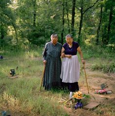 Sisters Maxine Wildcat Barnett (1925–2021) (left) and Josephine Wildcat Bigler (1921–2016);[8] two of the last elderly speakers of Yuchi, visiting their grandmother's grave in a cemetery behind Pickett Chapel in Sapulpa, Oklahoma. According to the sisters, their grandmother had insisted that Yuchi be their native language.