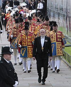English and Scottish heralds, wearing tabards, in procession during the Coronation of Charles III and Camilla (2023).