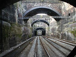 Liverpool Lime Street Approach. The original two-track tunnel was removed to create a deep cutting. Some of the road bridges seen across the cutting are solid rock and in effect are a series of short tunnels.