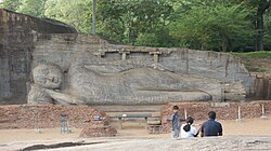 Reclining Buddha at Gal Vihara, Sri Lanka, where the remains of two columns to support the structure that originally enclosed it are visible