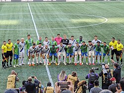 The starting lineups of Seattle Sounders FC (in green) and Monterrey (in white) prior to their group stage match