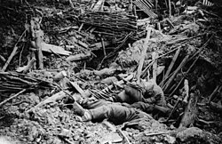 Dead German soldiers lie in the rubble of a trench destroyed by mine explosion, Messines Ridge, 1917